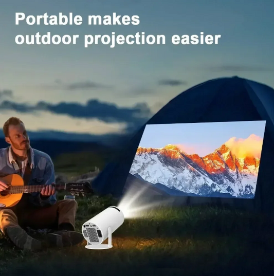 Man playing guitar with a portable 4k High Definition Projector projecting a mountain scene on a screen outdoors.