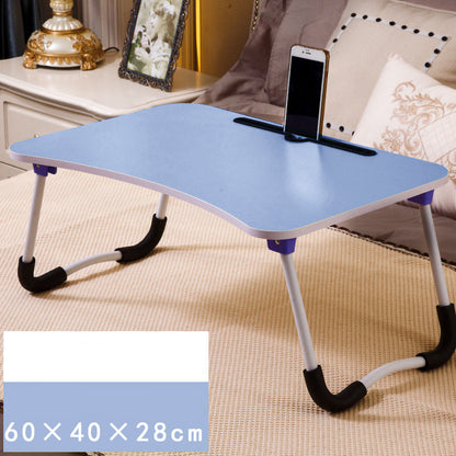 Portable folding table with phone stand on a carpeted floor.