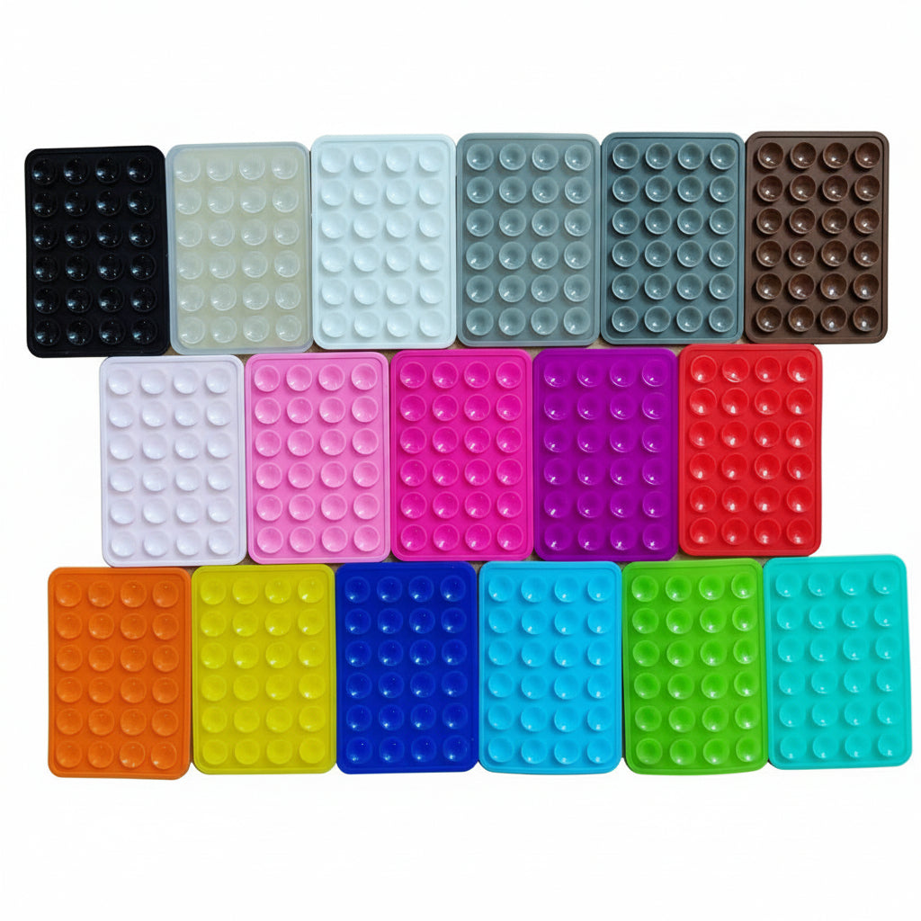 Assorted colorful silicone phone suction mounts on a white background