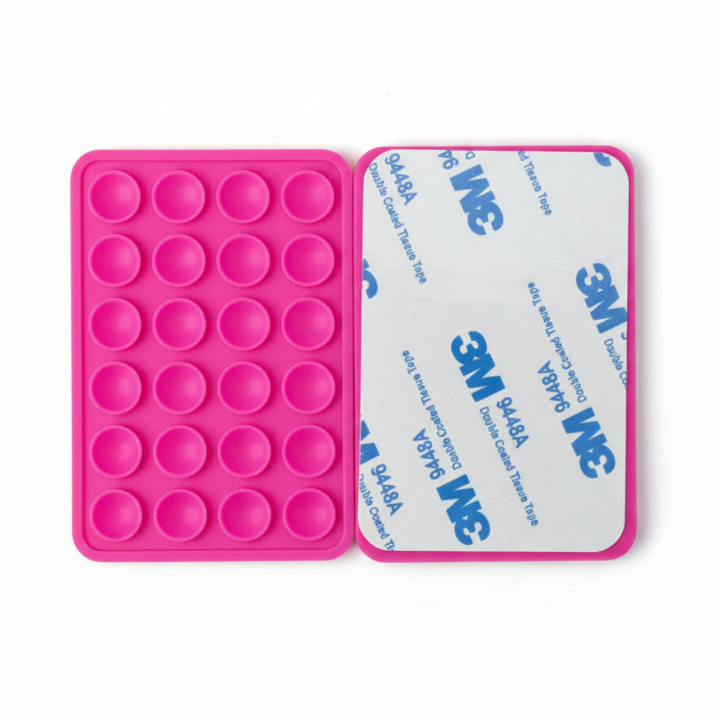 Pink silicone phone mount with 3M tape on a white background