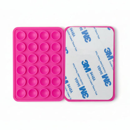 Pink silicone phone mount with 3M tape on a white background