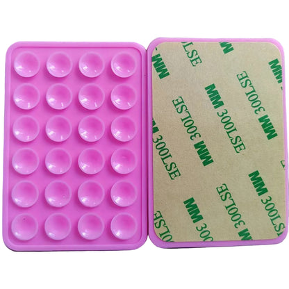 Pink silicone phone mount with circular cavities on a white background