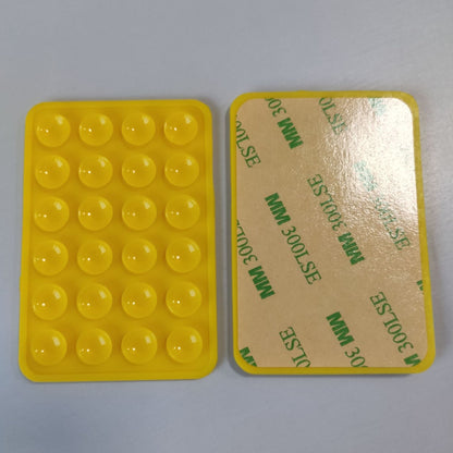 Yellow silicone mold with bubble texture on a cardboard backing with visible text.