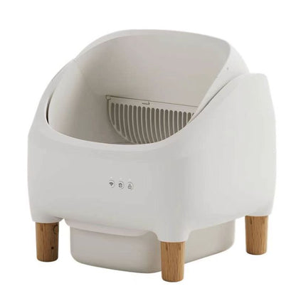 White pet litter box with wooden legs on a white background