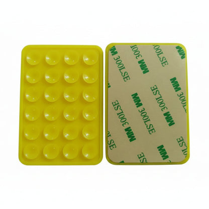 Yellow silicone mold with bubble texture on one side and green text on the other, on a gray background.