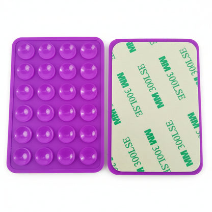 Purple silicone mold with green adhesive backing on a gray background