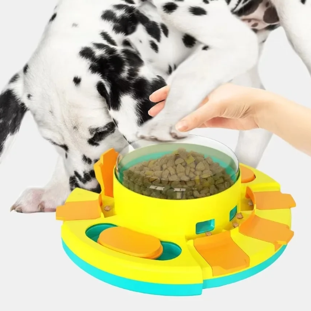 Dog interacting with a puzzle feeder filled with kibble, with a Dalmatian in the background.